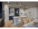 Modern kitchen with navy cabinets, light countertops, a large island, and stylish pendant lighting at 39210 Anthony St, Elizabeth, CO 80107