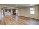 Spacious open-concept living room featuring wood floors and a view of the modern kitchen at 39210 Anthony St, Elizabeth, CO 80107