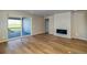 Cozy living room featuring a modern fireplace, wood floors, and access to the outdoor patio at 39210 Anthony St, Elizabeth, CO 80107