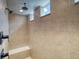 Walk-in shower features neutral tile surround, bench and shower head with natural light at 39210 Anthony St, Elizabeth, CO 80107