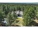 Stunning aerial view of a home surrounded by lush greenery and mature trees in a private setting at 4726 Pinon Dr, Elizabeth, CO 80107
