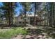 Back exterior of home with large deck, perfect for entertaining and enjoying the surrounding nature at 4726 Pinon Dr, Elizabeth, CO 80107