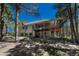 Exterior view of a home with a spacious, shaded back porch and tiered landscaping at 4726 Pinon Dr, Elizabeth, CO 80107