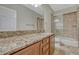 The bathroom has a spacious vanity with granite countertops and a glass-enclosed shower, combining style and functionality at 4726 Pinon Dr, Elizabeth, CO 80107