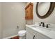 Powder bathroom features a white vanity, oval mirror, and a modern sink and fixtures at 4726 Pinon Dr, Elizabeth, CO 80107