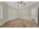 Bedroom featuring a ceiling fan and view into the hallway and ensuite bathroom at 4726 Pinon Dr, Elizabeth, CO 80107