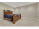Well-lit bedroom featuring a dark-wood bed frame and neutral walls at 4726 Pinon Dr, Elizabeth, CO 80107