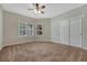Bedroom featuring a ceiling fan, carpeted floors, and double slider closet doors for maximum storage at 4726 Pinon Dr, Elizabeth, CO 80107
