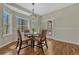 Bright dining nook features wood floors and large windows with views of the surrounding forest at 4726 Pinon Dr, Elizabeth, CO 80107