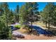 View of a long driveway approaching a home surrounded by trees at 4726 Pinon Dr, Elizabeth, CO 80107