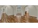 Bright foyer featuring arched entryways, hardwood floors, and a view of the front door and adjacent rooms at 4726 Pinon Dr, Elizabeth, CO 80107