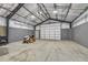 Spacious garage with concrete floors, ample lighting and a small yard tractor at 4726 Pinon Dr, Elizabeth, CO 80107