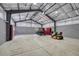 Inside this large garage are workbenches, lawn equipment, and room for parking at 4726 Pinon Dr, Elizabeth, CO 80107