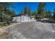 Spacious garage with driveway and additional building or apartment, providing ample parking and storage at 4726 Pinon Dr, Elizabeth, CO 80107