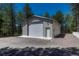 This detached garage has a large door with a gravel parking area at 4726 Pinon Dr, Elizabeth, CO 80107