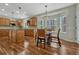 Eat-in kitchen with wooden cabinets, island, granite countertops, stainless steel appliances, and a bay window with treed view at 4726 Pinon Dr, Elizabeth, CO 80107
