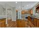 Spacious kitchen with an island, stainless appliances, wooden cabinets, granite countertops, and an arched entryway at 4726 Pinon Dr, Elizabeth, CO 80107