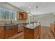 Open kitchen featuring granite counters, stainless appliances, hardwood floors, and windows with treed views at 4726 Pinon Dr, Elizabeth, CO 80107