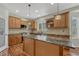 Spacious kitchen features a large granite island, custom cabinets, stone backsplash and stainless appliances at 4726 Pinon Dr, Elizabeth, CO 80107