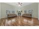 Cozy living room with hardwood floors, a fireplace, and large windows offering natural light at 4726 Pinon Dr, Elizabeth, CO 80107