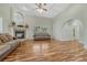 Open-concept living room showcasing hardwood floors, a stone fireplace, and abundant natural light at 4726 Pinon Dr, Elizabeth, CO 80107