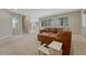 Bright living room with plush carpeting, large windows, and a comfortable leather sectional couch at 4726 Pinon Dr, Elizabeth, CO 80107