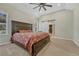 Bright main bedroom with ceiling fan, plush carpeting, and access to the ensuite bathroom through a sliding barn door at 4726 Pinon Dr, Elizabeth, CO 80107