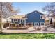 A spacious backyard featuring a large patio, fire pit area, well-maintained lawn, and inviting outdoor space at 482 Southpark Rd, Highlands Ranch, CO 80126
