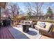 Backyard patio with outdoor seating, a fire pit table, grill, and mature trees creating a relaxing atmosphere at 482 Southpark Rd, Highlands Ranch, CO 80126