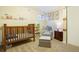 A cozy Bedroom featuring a wooden crib, comfortable chair and ottoman, and playful construction-themed decor at 482 Southpark Rd, Highlands Ranch, CO 80126