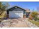 Home exterior with a well-maintained lawn and a two-car garage and brick accents at 482 Southpark Rd, Highlands Ranch, CO 80126