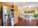 Kitchen with stainless steel refrigerator and adjacent dining area with backyard access at 482 Southpark Rd, Highlands Ranch, CO 80126