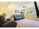 Cozy living room with comfortable leather seating, neutral carpet, and a ceiling fan for added comfort at 482 Southpark Rd, Highlands Ranch, CO 80126