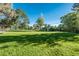 Backyard view of home with well maintained lawn and mature trees at 5982 S Aberdeen St, Littleton, CO 80120