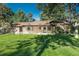 Backyard view of home with well maintained lawn and access to back entrance at 5982 S Aberdeen St, Littleton, CO 80120