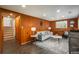 Cozy basement featuring wood paneling, comfortable seating, and stylish decor at 5982 S Aberdeen St, Littleton, CO 80120