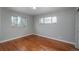 Bright bedroom features hardwood floors and natural light from two windows at 5982 S Aberdeen St, Littleton, CO 80120