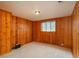 Bedroom featuring wood paneling, plush carpet, and natural light at 5982 S Aberdeen St, Littleton, CO 80120