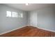 Bright bedroom with hardwood floors, a large window, and closet with sliding doors at 5982 S Aberdeen St, Littleton, CO 80120