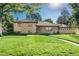 Exterior of home showcases manicured front lawn and charming brick facade at 5982 S Aberdeen St, Littleton, CO 80120