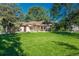 Inviting home boasting a large, green front yard with mature trees and brick exterior at 5982 S Aberdeen St, Littleton, CO 80120