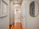 Hallway features wood floors, neutral paint, and decorative mirrors at 5982 S Aberdeen St, Littleton, CO 80120