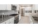 Modern kitchen featuring stainless steel appliances, granite countertops, and white cabinets at 5982 S Aberdeen St, Littleton, CO 80120