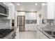 Updated kitchen featuring stainless steel appliances, granite countertops, and white cabinets at 5982 S Aberdeen St, Littleton, CO 80120