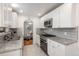 Updated kitchen featuring stainless steel appliances and granite countertops at 5982 S Aberdeen St, Littleton, CO 80120