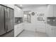 Bright kitchen featuring stainless steel appliances, granite countertops, and white cabinets at 5982 S Aberdeen St, Littleton, CO 80120
