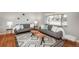 Bright living room with hardwood floors, comfortable sofas, and decorative rug at 5982 S Aberdeen St, Littleton, CO 80120