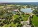 Beautiful aerial view of a lush park with lakes, winding paths, and historic buildings under a clear blue sky at 2377 Cherry St, Denver, CO 80207