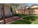 Secluded backyard featuring a wooden fence, small deck, and lush green grass at 2377 Cherry St, Denver, CO 80207