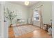 Bright bedroom with hardwood floors, large window, and neutral decor at 2377 Cherry St, Denver, CO 80207